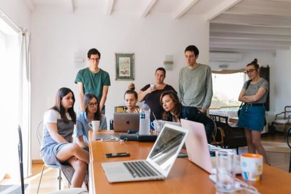 Collaborative work environment Group Of People Watching On Laptop 1595385